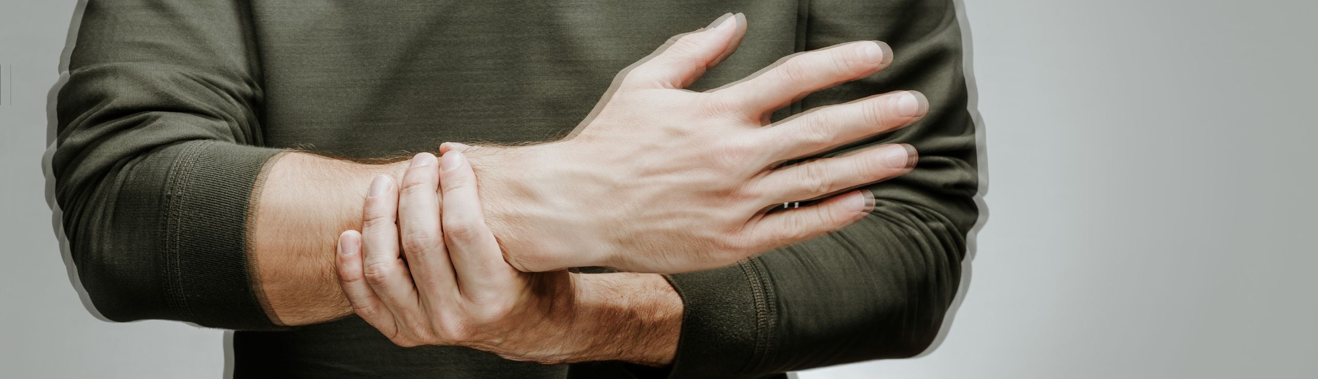 Image of somone holding their wrist from pain.