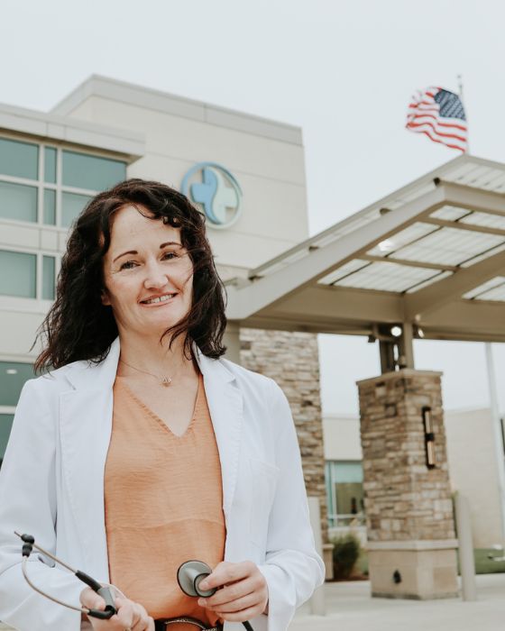 Dr. Jessica Crow stands in front of Hegg Health Center in Rock Valley, IA.