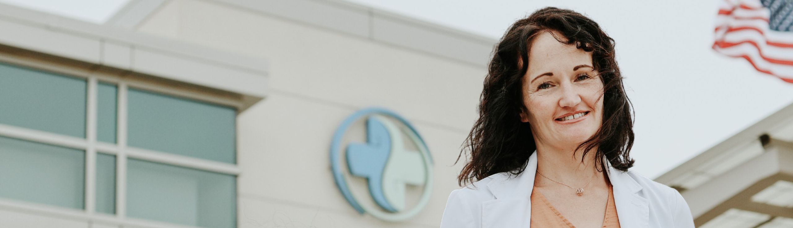 Dr. Jessica Crow standing in front of Hegg Health Center in Rock Valley, Iowa.